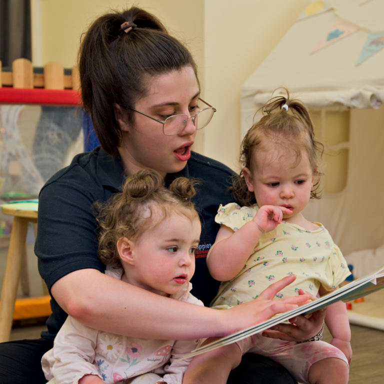 Babies at Poppies Nursery being read a story