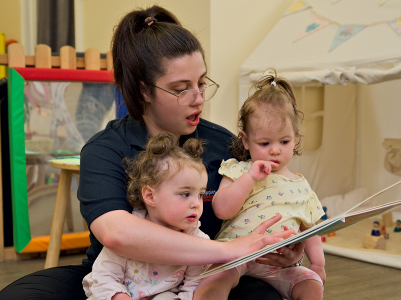 Babies at Poppies Nursery being read a story