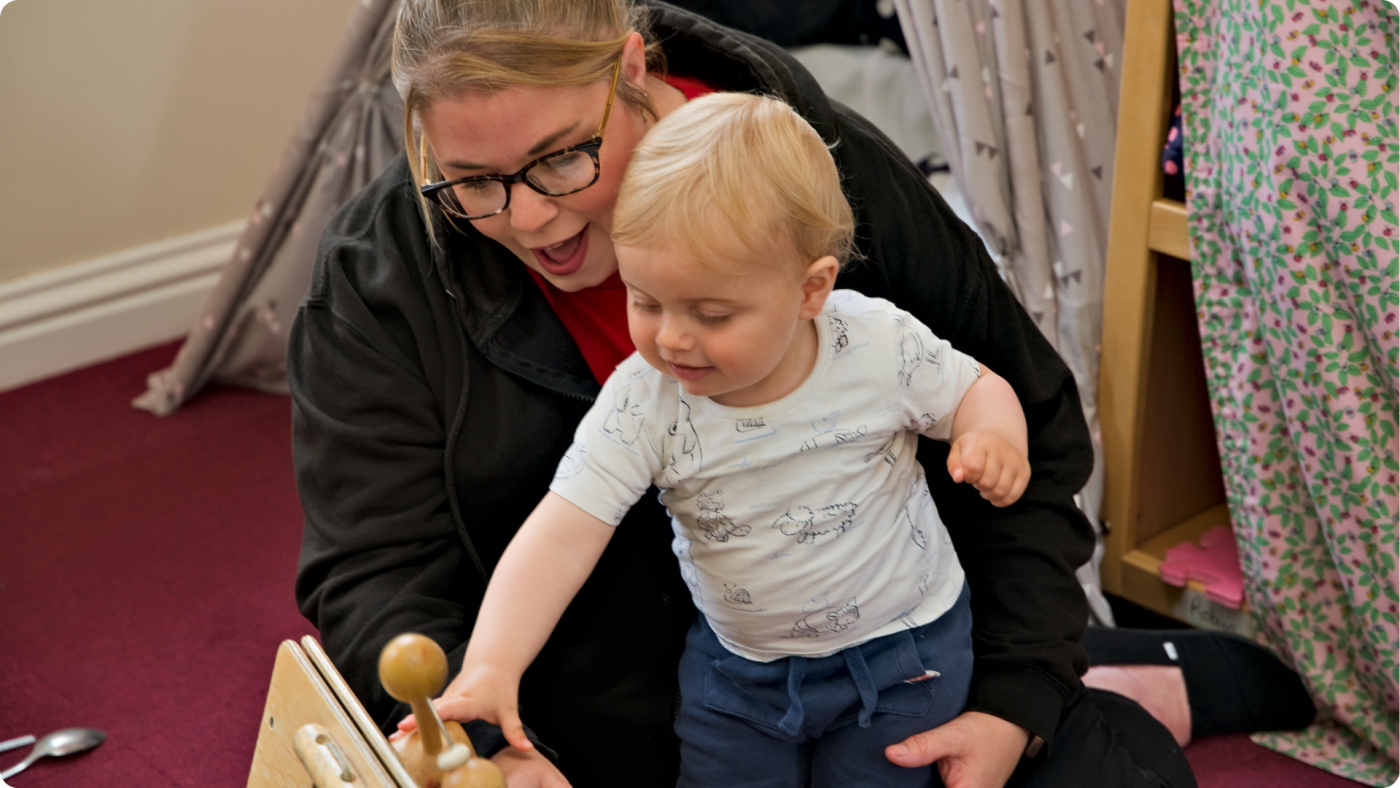 A baby playing with our staff at the Poppies Perham Down Nursery: When Is the Right Time to Put My Child Into a Nursery