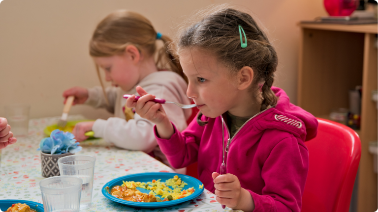 Healthy Eating in the Early Years - 2 children eating a well balanced meal in Poppies Daycare Nursery