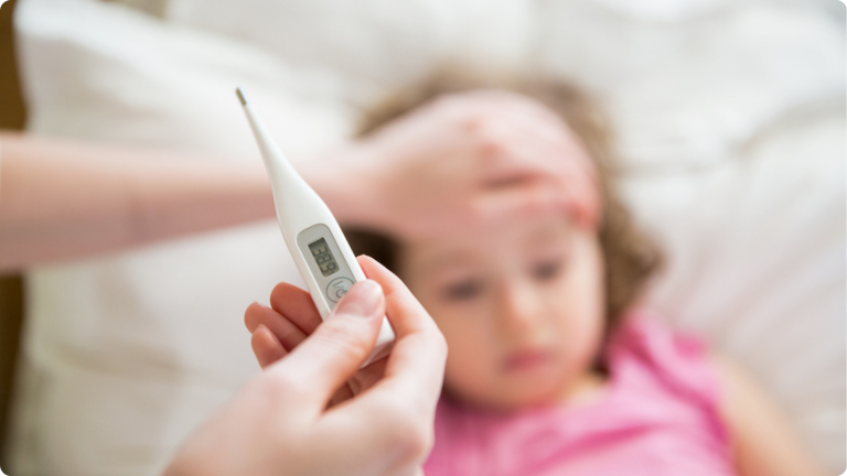 Is My Child Well Enough for Nursery? A parent checking their thermometer 