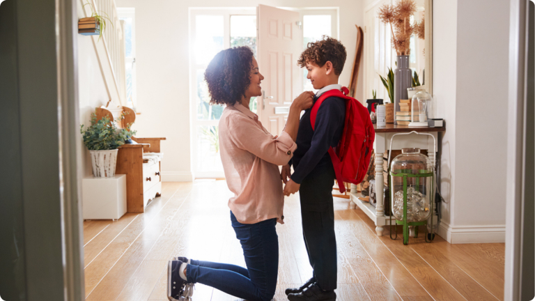A woman and her child getting ready for school after reading this blog and taking action to apply for primary school