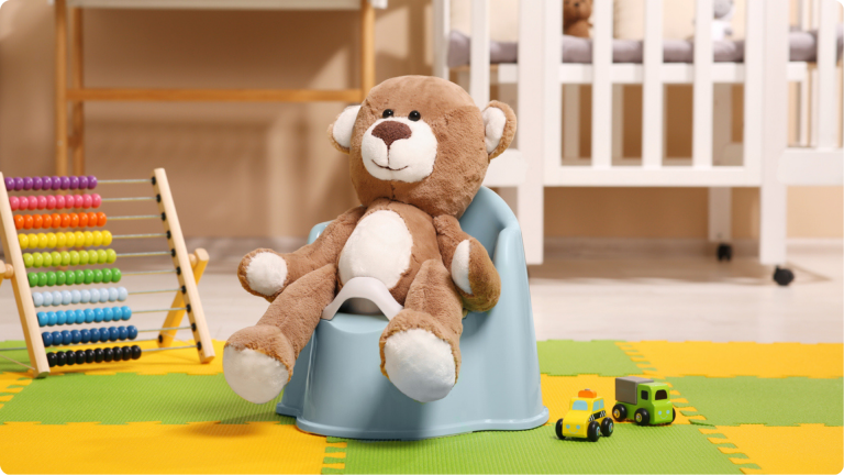 how to start potty training: mimic using toys and teddys. A teddy pretending to use the potty