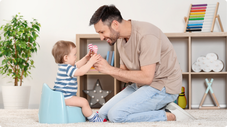 how to start potty training - a parent encouraging their child on the potty