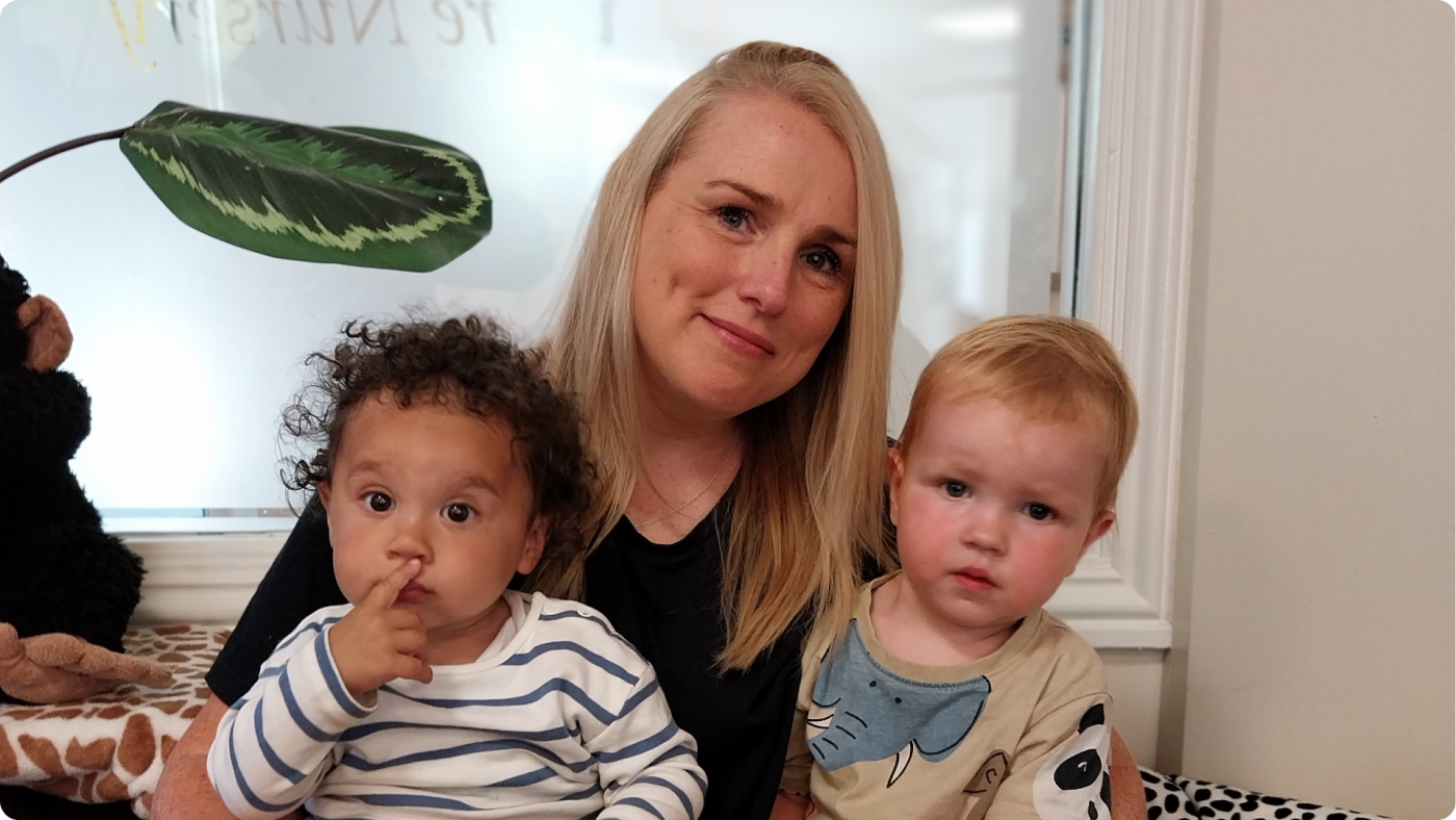 What Makes a Good Nursery Practitioner - shown by a Poppies team member readng to the babbies in the baby room