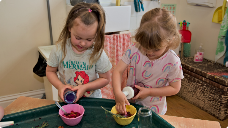 Parallel play in action with 2 children playing alongside each other but not interacting showing one of the 4 Types of Play in Child Development