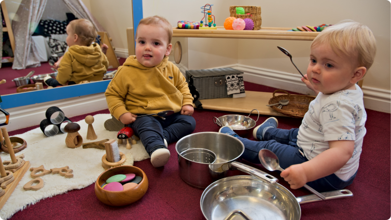 Two babies playing with sensory toys showing one of the 4 Types of Play in Child Development