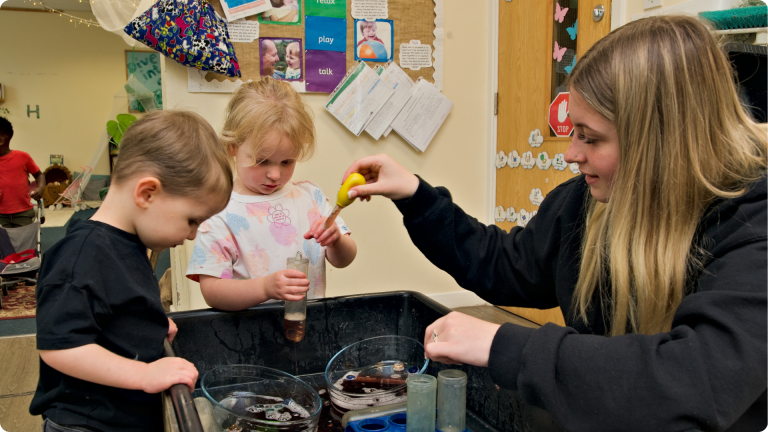 What Do They Teach in Nursery shown by nursery team members teaching children