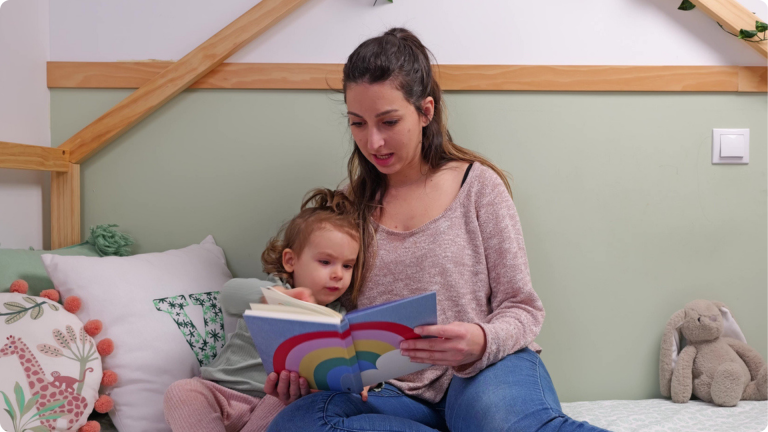 Activities to Promote Independence in Toddlers shown by a mum reading a book to her toddler who picked what they wanted to read